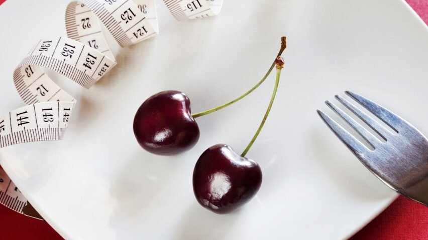 plate with cherries, fork, and measuring tape