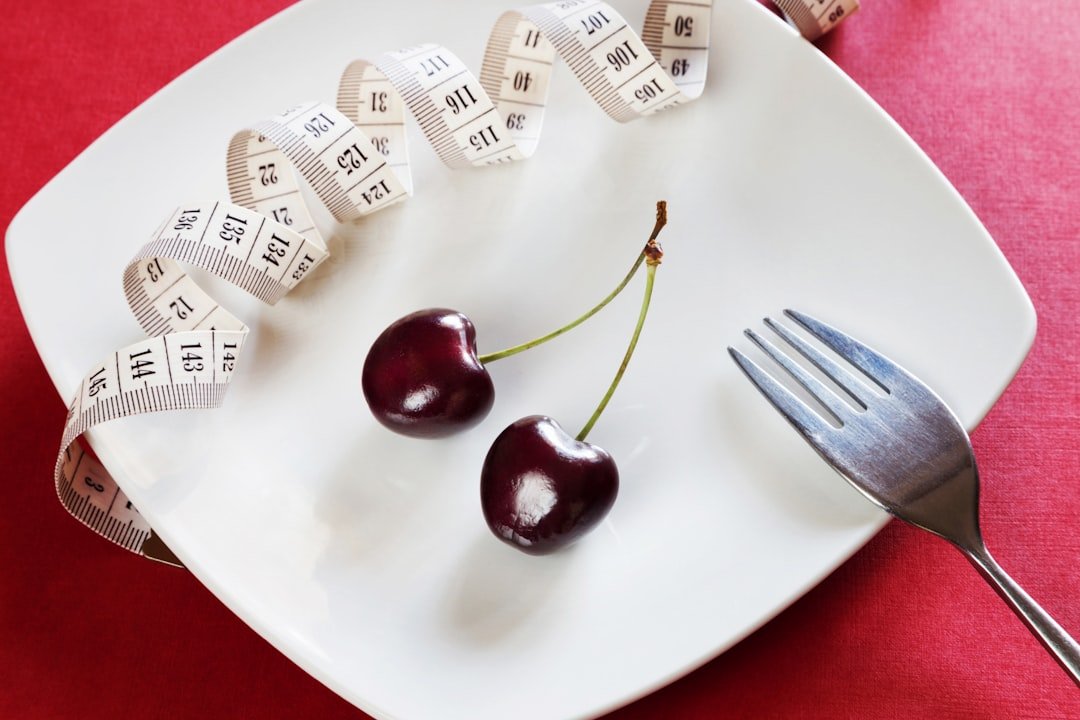 plate with cherries, fork, and measuring tape